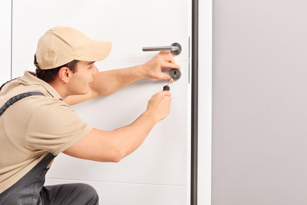 Worker Installing Door Lock