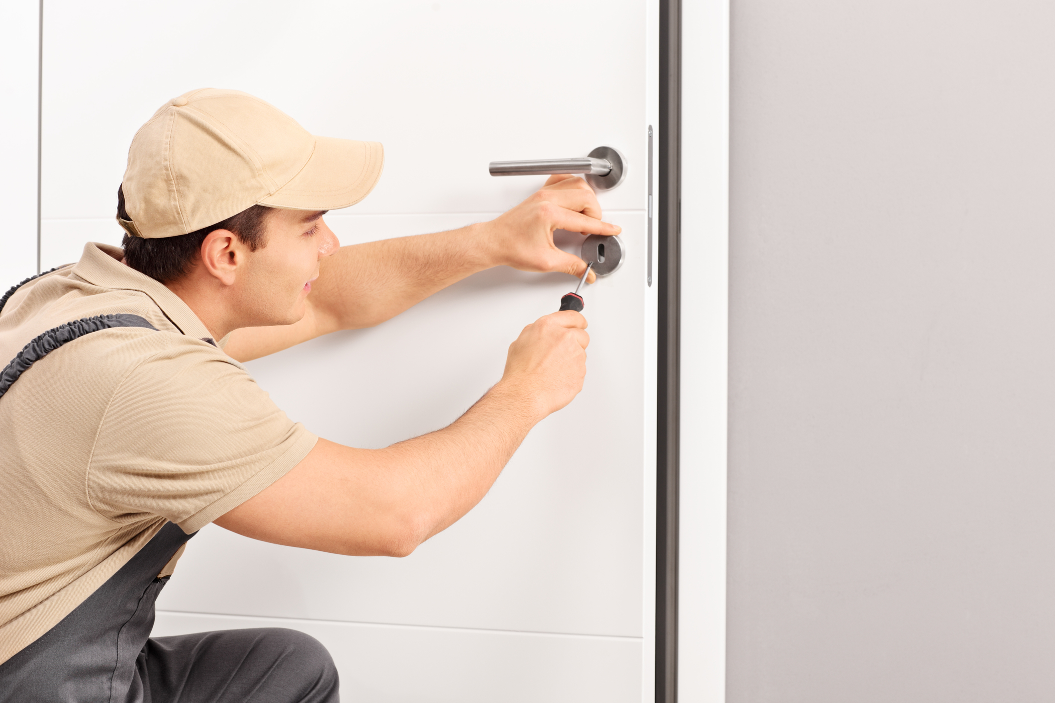 Man fixing lock on door