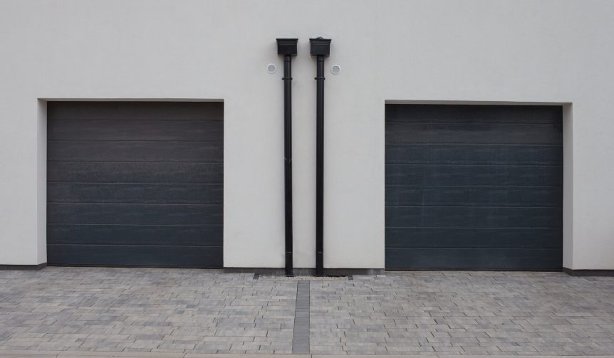 Two modern new gray garage doors (sectional doors) in a residential district.